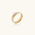 Gold-plated double-band ring with center rhinestone solitaire and channel-set stones on white background